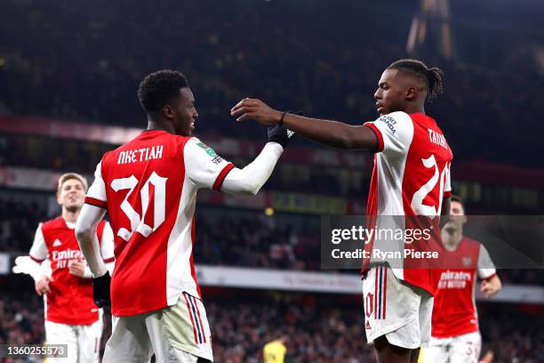 Eddie Nketiah of Arsenal celebrates with teammate Nuno Tavares after scoring their team's fourth goal and his hat-trick during the Carabao Cup...