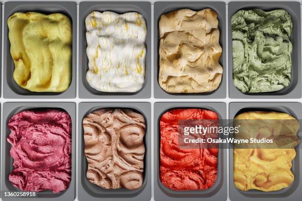 top down view of various ice cream in cooled counter - sweet shop stock-fotos und bilder