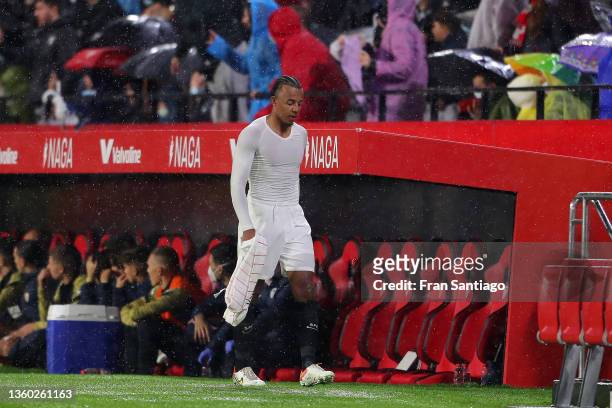 Jules Kounde of Sevilla walks off the pitch after he is shown the red card by the match referee during the LaLiga Santander match between Sevilla FC...