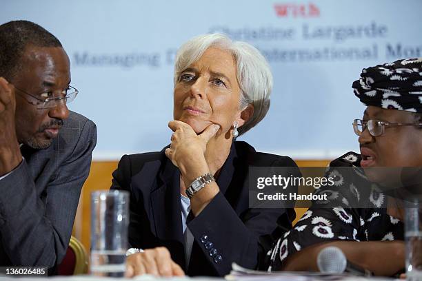 In this handout image provided by the International Monetary Fund , International Monetary Fund's Managing Director Christine Lagarde sits between...