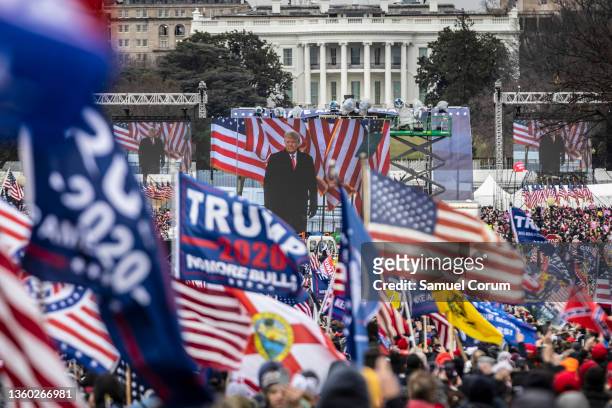 President Donald Trump is seen on a screen as his supporters cheer during a rally on the National Mall on January 6, 2021 in Washington, DC. Trump...