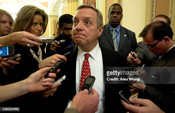 Senate Majority Whip Sen. Richard Durbin pauses as he answers questions from the media after he met with fellow Senate Democrats on a deal on payroll...