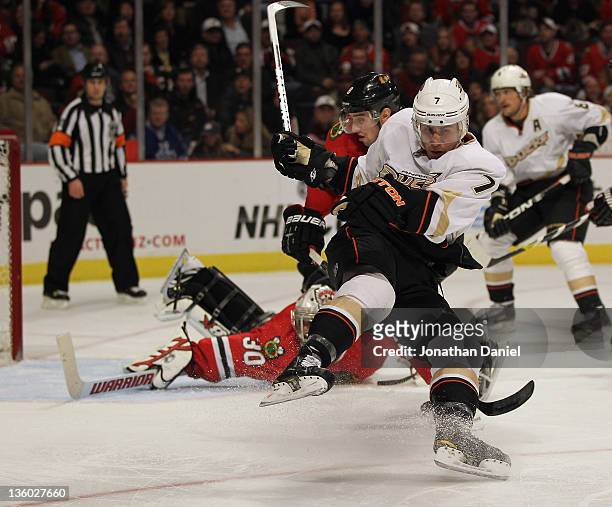 Andrew Cogliano of the Anaheim Ducks slips down on the ice after trying to get off a shot against Ray Emery of the Chicago Blackhawks after being...