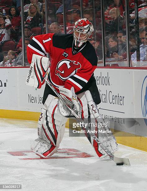 Johan Hedberg of the New Jersey Devils plays the puck against the Dallas Stars during the game at the Prudential Center on December 16, 2011 in...