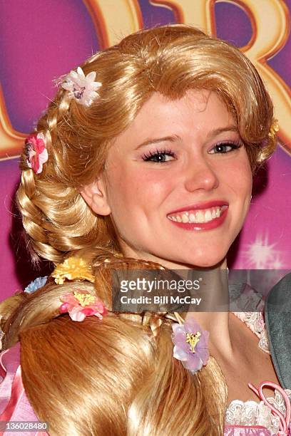Ice skater from Disney On Ice's 'Dare To Dream' show dressed as Disney cartoon character Rapunzel attends a book reading at the Please Youch Museum...