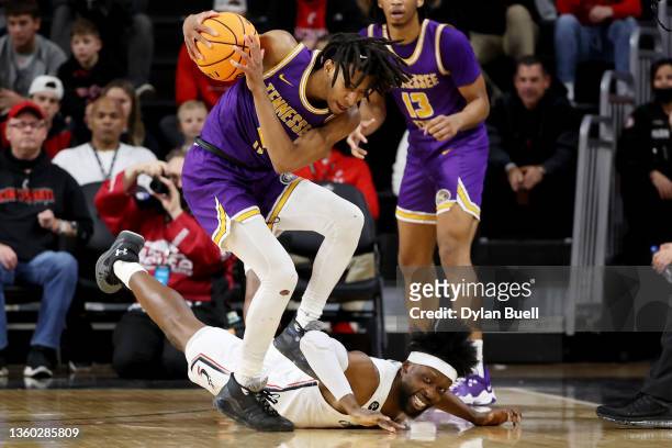 Jr. Clay of the Tennessee Tech Golden Eagles and John Newman III of the Cincinnati Bearcats battle for a loose ball in the second half at Fifth Third...