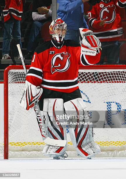 Johan Hedberg of the New Jersey Devils pumps his fist in celebration after defeating the Dallas Stars during the game at the Prudential Center on...