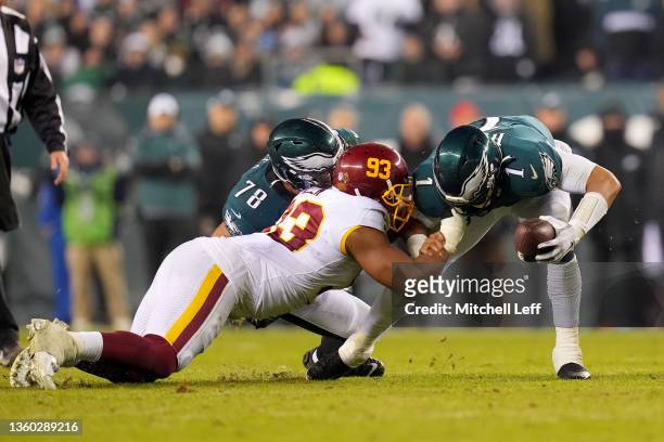 Jonathan Allen of the Washington Football Team sacks Jalen Hurts of the Philadelphia Eagles during the third quarter at Lincoln Financial Field on...