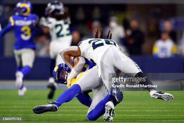 Brycen Hopkins of the Los Angeles Rams is tackled by Ryan Neal of the Seattle Seahawks at SoFi Stadium on December 21, 2021 in Inglewood, California.