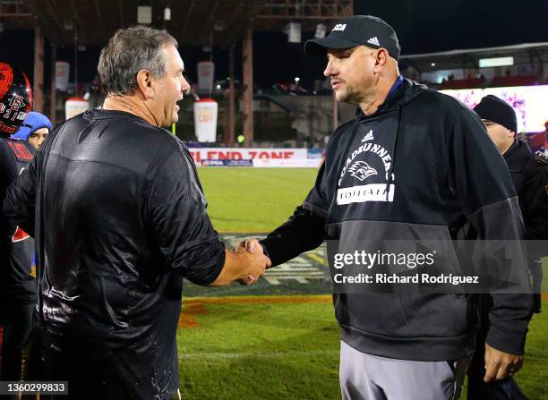 Head coach Brady Hoke of the San Diego State Aztecs shakes hands with head coach Jeff Traylor of the UTSA Roadrunners after the Aztecs beat the...