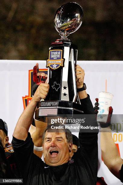 Head coach Brady Hoke of the San Diego State Aztecs holds up the trophy after the 38-24 win over the UTSA Roadrunners in the Tropical Smoothie Cafe...