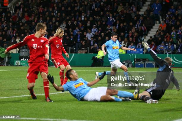 Giovanni Frederico of Bochum scores the first goal against Manuel Neuer of Muenchen during the DFB Cup round of sixteen match between VfL Bochum and...