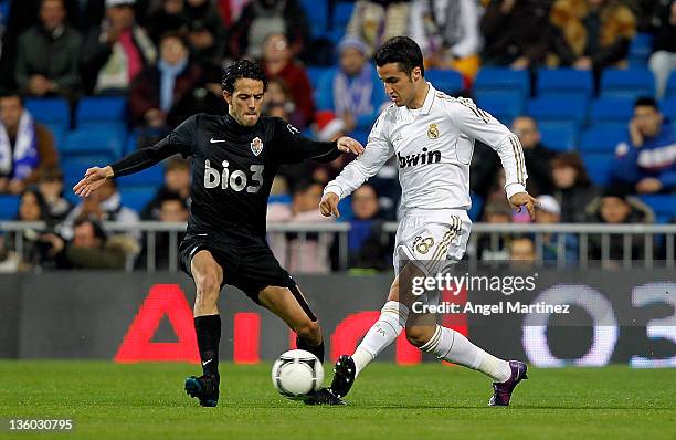 Jorge Casado of Real Madrid is challenged by Mateo Miguez of Ponferradina during the round of last 16 Copa del Rey second leg match between Real...