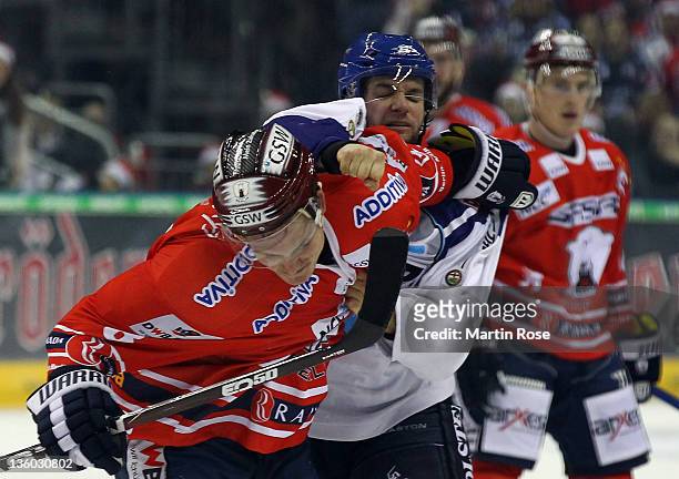 Nicholas Angell of Berlin fights with Charles Cook of Hamburg during the DEL Bundesliga match between EHC Eisbaeren Berlin and Hamburg Freezers at O2...