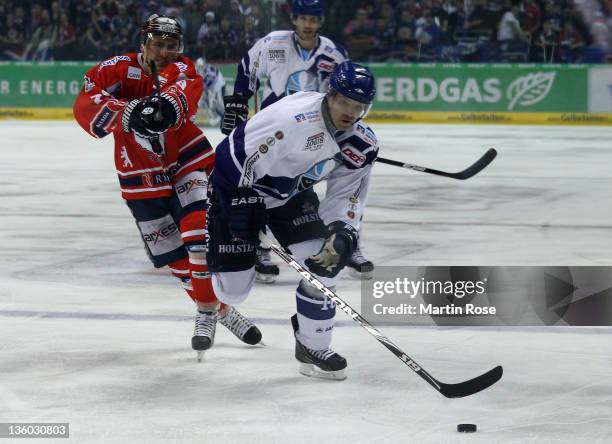 Jens Baxmann of Berlin and Robert Collins of Hamburg battle for the puck during the DEL Bundesliga match between EHC Eisbaeren Berlin and Hamburg...