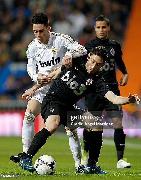 Jose Callejon of Real Madrid fights for the ball with David Malo of Ponferradina during the round of last 16 Copa del Rey second leg match between...