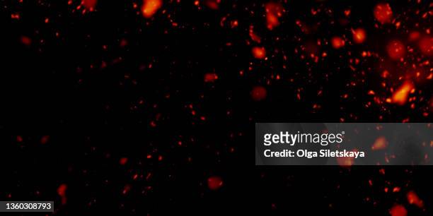 sparks on black background - fire stock pictures, royalty-free photos & images