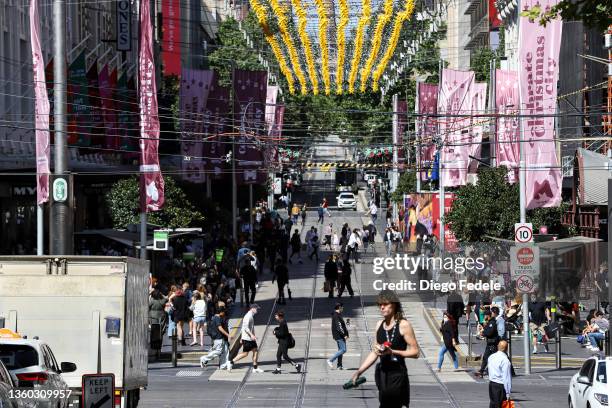 People walk along Bourke Street Mall on December 22, 2021 in Melbourne, Australia. Victoria's COVID-19 case numbers are on the increase across the...