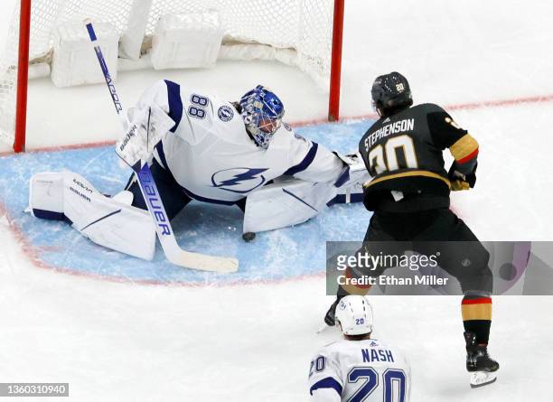 Andrei Vasilevskiy of the Tampa Bay Lightning makes a save against Chandler Stephenson of the Vegas Golden Knights in the third period of their game...