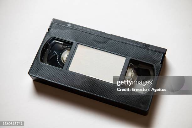 vhs videocassetes over white background - videocassette stock pictures, royalty-free photos & images