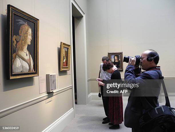 Journalists take photos of a painting by Sandro Botticelli called Ideal Portrait of a Lady during a press preview at the Metropolitan Museum of Art...