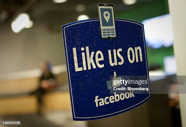 Sign that reads "Like us on Facebook" is displayed in the entry way at Facebook Inc.'s office in New York, U.S., on Tuesday, Dec. 20, 2011. "Cool...