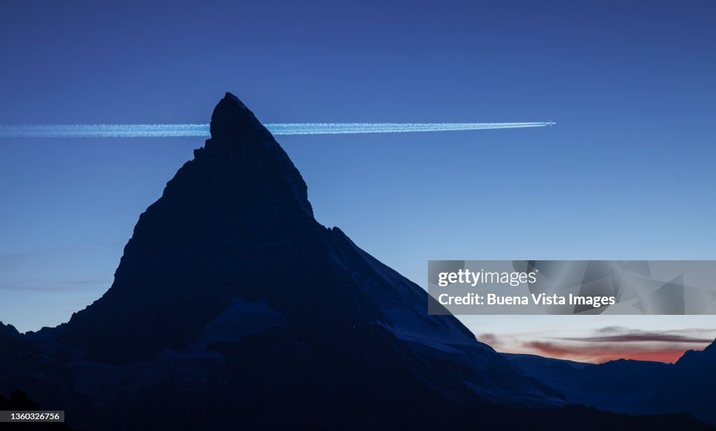 Commercial jet flying over the Matterhorn
