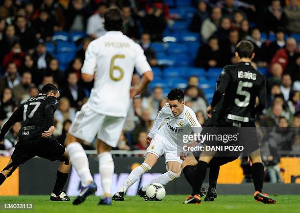 Real Madrid's forward Jose Callejon vies with Ponferradina's defenders during the Spanish King's Cup football match Real Madrid CF vs Ponferradina on...