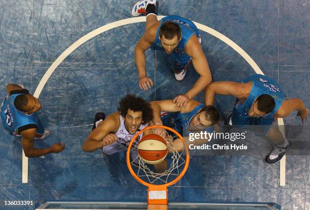 Matthew Knight of the Wildcats shoots as Mark Worthington of the Blaze tries to block hi shot during the round 11 NBL match between the Gold Coast...