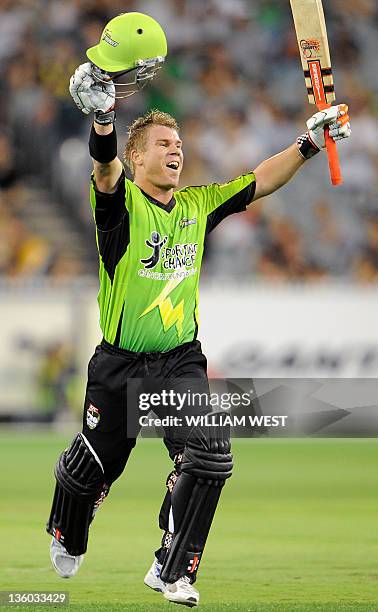 Sydney Thunder batsman David Warner celebrates scoring his century against the Melbourne Stars during their T20 Big Bash cricket match at the...