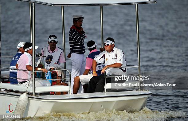 Prom Meesawat of Thailand rides the Amata boat to the 17th green during day three of the Thailand Golf Championship at Amata Spring Country Club on...