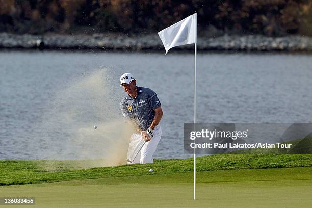 Lee Westwood hits out of a bunker during day three of the Thailand Golf Championship at Amata Spring Country Club on December 17, 2011 in...