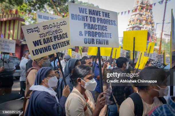 Activists wave placards as they participate in a demonstration against the tabling of the Protection of Right to Freedom of Religion Bill on December...