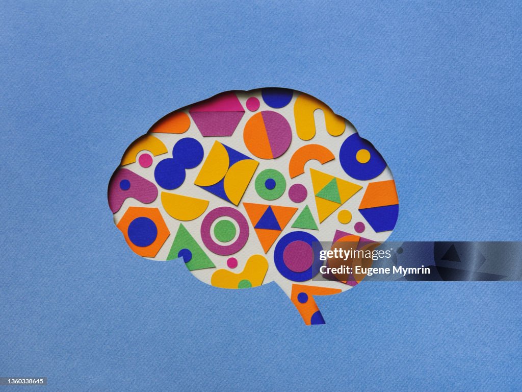 Paper brain silhouette with geometric shapes