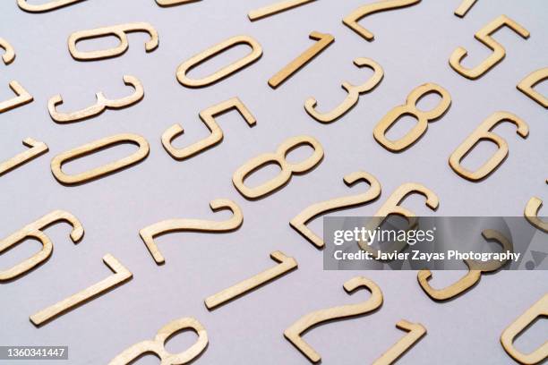 group of wooden numbers on gray background - wirtschaftszahlen stock-fotos und bilder