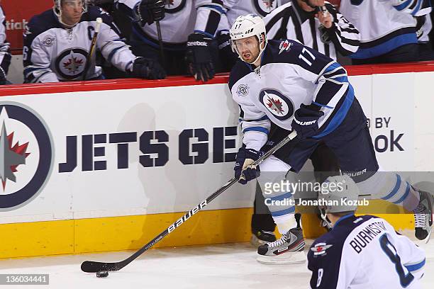 Eric Fehr of the Winnipeg Jets carries the puck through the neutral zone during first period action against the Anaheim Ducks at the MTS Centre on...