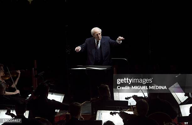 French composer and conductor Pierre Boulez directs the Paris Orchestra under the Louvre Pyramid during a free concert on December 21, 2011 in Paris....