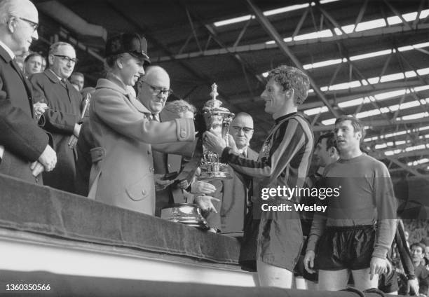 Princess Anne presents the Football Association trophy to Manchester City Football Club team captain Tony Book after winning the FA Cup Final match...