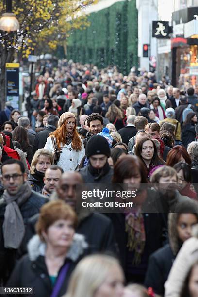 Consumers peruse the shops on Oxford Street on the penultimate Saturday before Christmas Day on December 17, 2011 in London, England. Retail analysts...