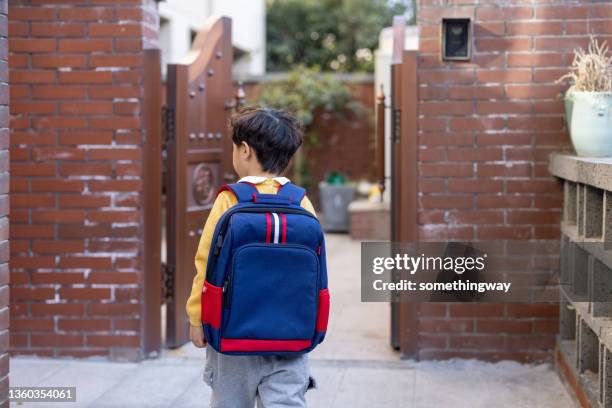 a little boy coming home from school - coming back stock pictures, royalty-free photos & images