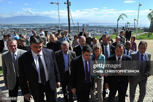 French Prime Minister François Fillon flanked by French Sport Minister David Douillet and Industry Minister Eric Besson with Rio's governor Sergio...