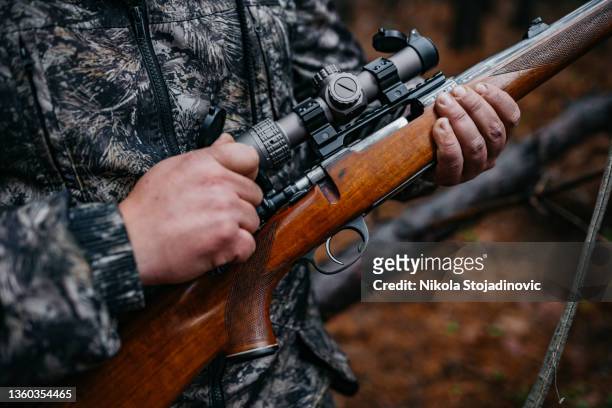 the hunter prepares the rifle - distant fire stock pictures, royalty-free photos & images