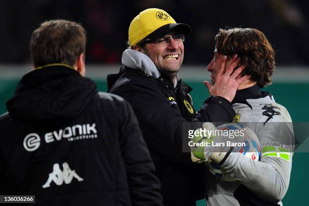 Head coach Juergen Klopp of Dortmund celebrates with goalkeeper Roman Weidenfeller after winning the DFB Cup third round match between Fortuna...