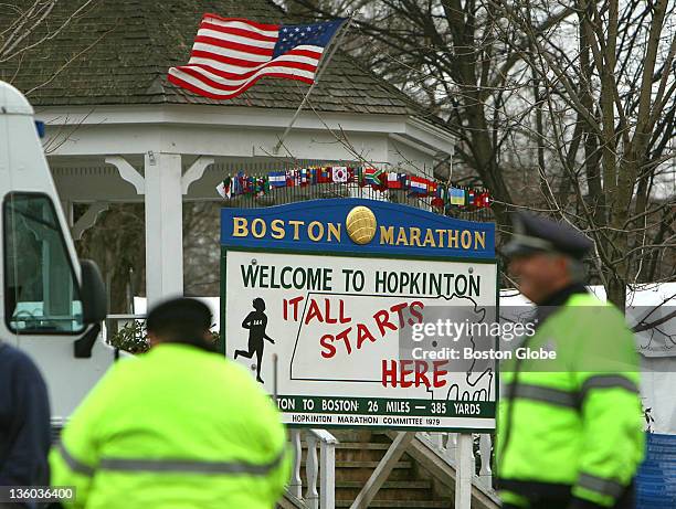 Flag blows in strong winds on the Hopkinton Common gazebo, as Hopkinton police stand by while work is being done on Main Street. Bleachers and sound...