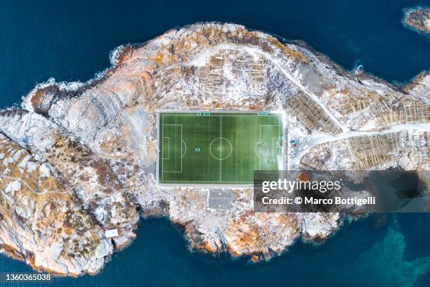 overhead view of a football field surrounded by snow in norway - sport extreme stock-fotos und bilder