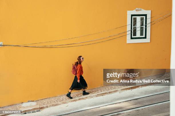 Young woman exploring Lisbon city on foot