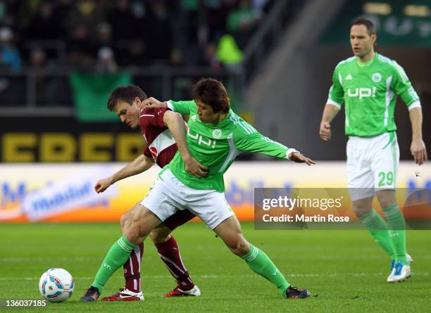 Koo Ja Cheol of Wolfsburg and William Kvist of Stuttgart battle for the ball during the Bundesliga match between VfL Wolfsburg and VfB Stuttgart at...