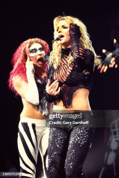 With an unidentified dancer , American Pop singer Britney Spears performs onstage, during her 'Dream Within a Dream' tour, at Continental Airlines...