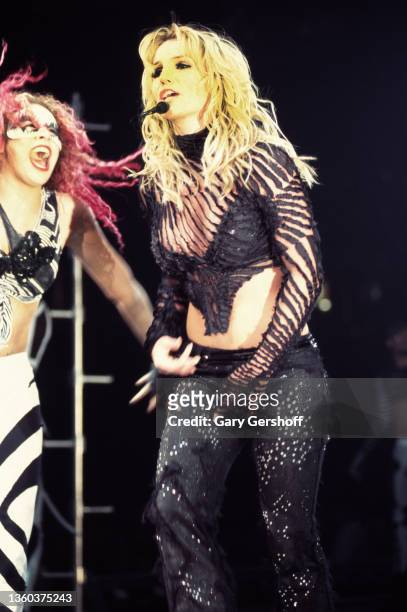 With an unidentified dancer , American Pop singer Britney Spears performs onstage, during her 'Dream Within a Dream' tour, at Continental Airlines...