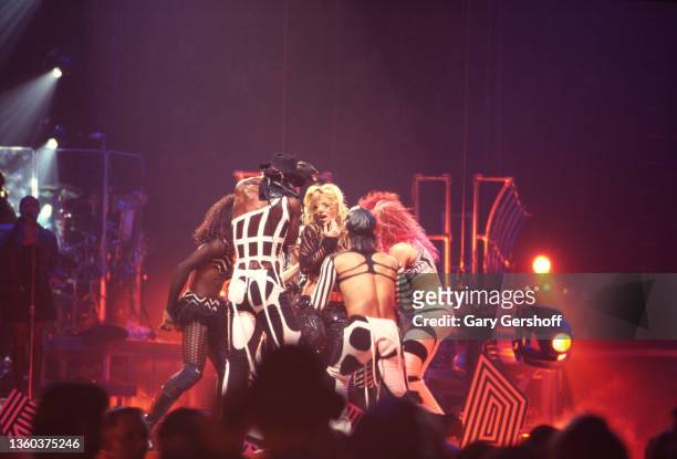 American Pop singer Britney Spears , with unidentified dancers, performs onstage, during her 'Dream Within a Dream' tour, at Continental Airlines...